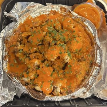 Loaded mac and cheese with orange sauce drizzle at Mac Daddy